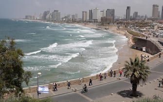 epa07554423 Tourists walk on the Jaffa promenade, backdropped by the skyline of Tel Aviv, Israel, 07 May 2019. According to the municipality, 10,000 to 20,000 tourists are expected to visit the city for the Eurovision Song Contest (ESC) that takes place from 14 to 18 May 2019.  EPA/ABIR SULTAN