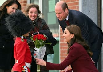 Prince William, Prince of Wales and Catherine, Princess of Wales receive flowers from Henry Dynov-Teixeira, 8, as they depart Greentown Labs, which bills itself as the worlds largest climate technology startup incubator, in Somerville, Massachusetts, on December 1, 2022. (Photo by ANGELA WEISS / AFP) (Photo by ANGELA WEISS/AFP via Getty Images)