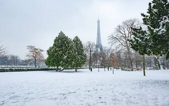 Eiffel tower under the snow from the Trocadero gardens in Paris, France