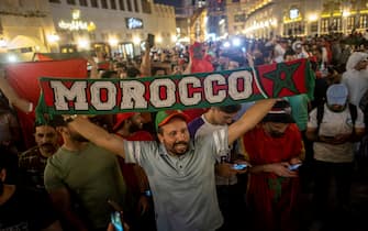 epa10352682 Fans of Morocco celebrate after Morocco won the FIFA World Cup 2022 Round of 16 match against Spain, at the Souq Waqif market in Doha, Qatar, 06 December 2022.  EPA/MARTIN DIVISEK