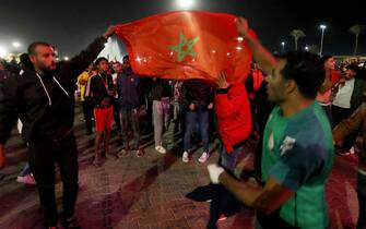 Morocco's supporters celebrate after their team won the Qatar 2022 World Cup round 16 football match between Morocco and Spain, in the Libyan capital Tripoli, on December 6, 2022. (Photo by Mahmud Turkia / AFP) (Photo by MAHMUD TURKIA/AFP via Getty Images)