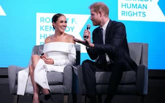 NEW YORK, NEW YORK - DECEMBER 06: Meghan, Duchess of Sussex and Prince Harry, Duke of Sussex speak onstage at the 2022 Robert F. Kennedy Human Rights Ripple of Hope Gala at New York Hilton on December 06, 2022 in New York City. (Photo by Kevin Mazur/Getty Images for 2022 Robert F. Kennedy Human Rights Ripple of Hope Gala)