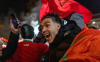 epa10359787 Supporters of Morocco celebrate their team winning the FIFA World Cup 2022 quarter final match between Morocco and Portugal on the Champs Elysees in Paris, France, 10 December 2022. EPA/CHRISTOPHE PETIT TESSON
