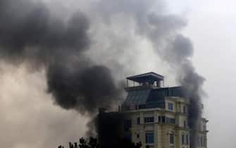 epa10361755 Smoke billows from a guest house after an attack in Kabul, Afghanistan, 12 December 2022. The Afghan capital was rocked by a loud blast and gunfire on 12 December, near one of the guest houses popular with Chinese business visitors.  EPA/STR
