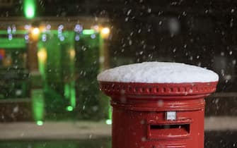 LONDON, UNITED KINGDOM - DECEMBER 11: A view of the snow covered mailbox during snowfall in London, United Kingdom on December 11, 2022. Officials announced that the most effective snowfall since 2013 is expected across the country. (Photo by Rasid Necati Aslim/Anadolu Agency via Getty Images)