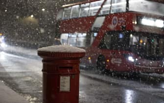 LONDON, UNITED KINGDOM - DECEMBER 11: A view of the snow covered mailbox during snowfall in London, United Kingdom on December 11, 2022. Officials announced that the most effective snowfall since 2013 is expected across the country. (Photo by Rasid Necati Aslim/Anadolu Agency via Getty Images)
