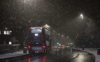 LONDON, UNITED KINGDOM - DECEMBER 11: Vehicles move during snowfall in London, United Kingdom on December 11, 2022. Officials announced that the most effective snowfall since 2013 is expected across the country. (Photo by Rasid Necati Aslim/Anadolu Agency via Getty Images)