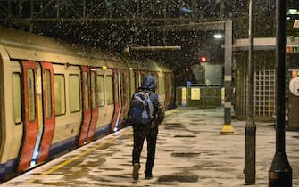 LONDON, ENGLAND - DECEMBER 11: Snow falls at Wembley Park Station as snow, ice and freezing fog sweep across the country on December 11, 2022 in London, England. The UK Health Security Agency (UKHSA) issued a cold-weather alert that will run until Monday morning, as many across the UK struggle with home-heating costs. (Photo by Jim Dyson/Getty Images)