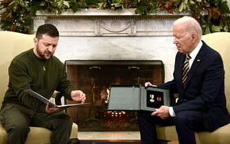 Ukraine's President Volodymyr Zelensky gives a medal to US President Joe Biden in the Oval Office of the White House, in Washington, DC on December 21, 2022. - Zelensky is in Washington to meet with US President Joe Biden and address Congress -- his first trip abroad since Russia invaded in February. (Photo by Brendan SMIALOWSKI / AFP) (Photo by BRENDAN SMIALOWSKI/AFP via Getty Images)