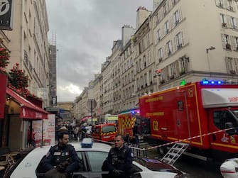 French police and security personnel corden off the area after several shots were fired along rue d'Enghien in the 10th arrondissement, in Paris on December 23, 2022. - Two people were killed and four injured in a shooting in central Paris on December 23, 2022, police and prosecutors said, adding that the shooter, in his 60s, had been arrested. The motives of the gunman remain unclear, with two of the four injured left in a serious condition, the French officials said. (Photo by Luka Bakaric-Mulholland / AFP) (Photo by LUKA BAKARIC-MULHOLLAND/AFP via Getty Images)