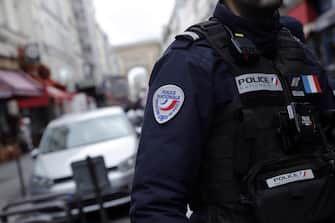 epa10377081 A French Police officer secures the perimeter on 'Rue d'Enghien' following a shooting incident near a Kurdish cultural centre in Paris, France, 23 December 2022. The Paris Police Prefecture annonced on its social media that a suspect was detained in connection to the incident.  EPA/TERESA SUAREZ