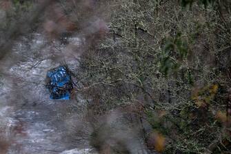 The wreck of a bus lies in the Lerez river after it plunged while crossing a bridge, killing four people, in Cerdedo-Cotobade, northwestern Spain, on December 25, 2022. - The accident occurred on December 24 night near Vigo and the border with Portugal. The regional La Voz de Galicia newspaper said the bus was carrying people visiting their loved ones jailed in Monterroso in central Galicia. Rescue operations had to be suspended overnight due to bad weather but resumed in the morning. (Photo by Brais Lorenzo / AFP) (Photo by BRAIS LORENZO/AFP via Getty Images)
