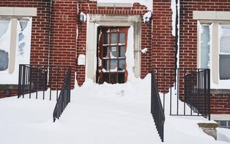 USA BUFFALO WINTER STORM epa10378186 An apartment complex door lies open as the effects of a massive winter storm which has affected large portions of the United States, continues in Buffalo, New York, USA, 25 December 2022. Much of the United States is currently experiencing some sort of winter weather as a result of the large storm which was generated by a bomb cyclone, the meteorological phenomenon when the atmospheric pressure quickly drops in a strong storm EPA/JOSH THERMIDOR