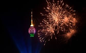 This photograph taken on January 1, 2023, shows fireworks in the sky next to the lit-up Lotus Tower during New Year celebrations in Colombo. (Photo by Ishara S. KODIKARA / AFP) (Photo by ISHARA S. KODIKARA/AFP via Getty Images)