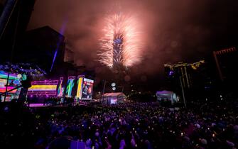 TAIPEI, TAIWAN - JANUARY 01: People celebrate as fireworks light up the skyline from the Taipei 101 building during New Year's celebrations on January 01, 2023 in Taipei, Taiwan. (Photo by Gene Wang/Getty Images)