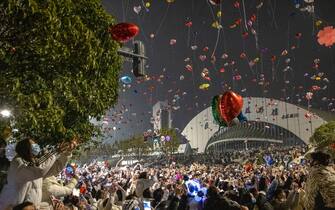 Revellers fly balloons during a New Year celebration in Wuhan, in China's central Hubei province on January 1, 2023. - China OUT (Photo by AFP) / China OUT (Photo by STR/AFP via Getty Images)