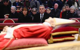 epa10387112 A handout picture provided by the Vatican Media shows Hungary's Prime Minister Viktor Orban (C), accompanied by his wife, Aniko Levai, paying their respects to late Pope Emeritus Benedict XVI (Joseph Ratzinger), lying in state inside the Saint Peter Basilica for public viewing, in Vatican City, 03 January 2023. Former Pope Benedict XVI died on 31 December 2022 at his Vatican residence, at the age of 95. For three days, starting from 02 January, the body will lay in state in St Peter's Basilica until the funeral on 05 January.  EPA/VATICAN MEDIA HANDOUT  HANDOUT EDITORIAL USE ONLY/NO SALES