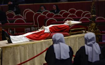 People observe a moment of silence as the body of the late Pope Emeritus Benedict XVI (Joseph Ratzinger) lies in the state in the Saint Peter Basilica for public viewing, Vatican City, 03 January 2023.ANSA/FABIO FRUSTACI