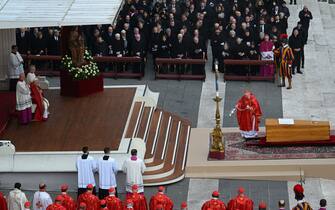 Italian Cardinal Giovanni Battista Re (R) swings a thurible opf incense over the coffin of Pope Emeritus Benedict XVI, as Pope Francis looks on (Top L) during his funeral mass at St. Peter's square in the Vatican on January 5, 2023. - Pope Francis is presiding on January 5 over the funeral of his predecessor Benedict XVI at the Vatican, an unprecedented event in modern times expected to draw tens of thousands of people. (Photo by Filippo MONTEFORTE / AFP) (Photo by FILIPPO MONTEFORTE/AFP via Getty Images)
