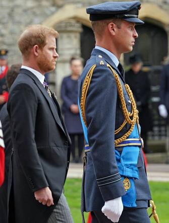 The Duke of Sussex and the Prince of Wales follow the State Hearse carrying the coffin of Queen Elizabeth II, draped in the Royal Standard with the Imperial State Crown and the Sovereign's Orb and Sceptre, as it arrives at the Committal Service held at St George's Chapel in Windsor Castle, Berkshire. Picture date: Monday September 19, 2022.