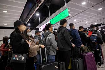 epa10394880 Travellers make their way to the Hong Kong immigration desks before crossing the border to China at Lok Ma Chau MTR station, in Hong Kong, China, 08 January 2023. From 08 January 2023, after three years of closures due to Covid-19 pandemic restrictions, at least 60,000 people a day are allowed to cross the Hong Kong-mainland China border each way without the need to undergo quarantine. Seven land, sea and air cross-border checkpoints have returned to regular operating hours after three years of closures or limited services under some of the world's toughest and longest pandemic restrictions. A negative polymerase chain action (PCR) test result taken within the past 48 hours is still required to travel to either side of the Hong Kong-China border.  EPA/JEROME FAVRE