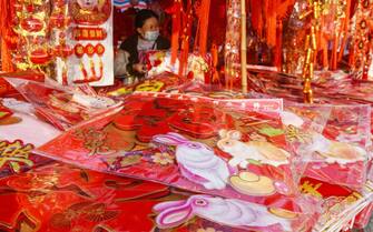FUYANG, ANHUI, CHINA - 2023/01/11: A female customer selects Spring Festival couplets and decorations in Fuyang for the Chinese Lunar New Year which falls on January 22 this year. (Photo by SheldonÂ Cooper/SOPA Images/LightRocket via Getty Images)