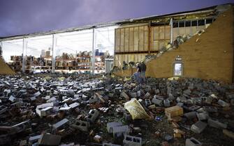 epa10402425 Workers assess tornado damage to the 18 Wheeler Truck Parts & Chrome warehouse following a tornado outbreak across multiple states in Austell, Georgia, USA, 12 January 2023.  EPA/ERIK S. LESSER