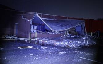epa10402471 A collapsed roof and wall scattered debris in a lot at a Hobby Lobby store following an outbreak across multiple states in Griffin, Georgia, USA, 12 January 2023.  EPA/ERIK S. LESSER