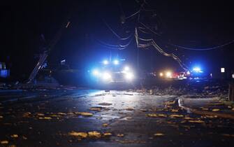 epa10402476 Police vehicles block a roadway among downed power lines following an outbreak across multiple states in Griffin, Georgia, USA, 12 January 2023.  EPA/ERIK S. LESSER