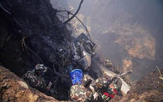 Rescuers inspect the site of a plane crash in Pokhara on January 15, 2023. - An aircraft with 72 people on board crashed in Nepal on January 15, Yeti Airlines and a local official said.  (Photo by Yunish Gurung/AFP) (Photo by YUNISH GURUNG/AFP via Getty Images)