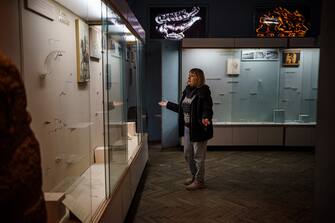 Olga Honcharova, temporary director of the Kherson Regional Museum, specialising in local history and natural history shows shows an empty glass display cases in Kherson, amid the Russian invasion of Ukraine. - Russian military forces and civilians operating under their orders pillaged thousands of valuable artifacts and artworks from two museums, a cathedral, and a national archive in Kherson, before withdrawing after an 8-month occupation of the city, Human Rights Watch said on December 20, 2022. (Photo by Dimitar DILKOFF / AFP) (Photo by DIMITAR DILKOFF/AFP via Getty Images)