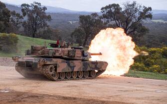 PUCKAPUNYAL, AUSTRALIA - 2022/08/05: An Abrams tank fires during an army firepower demonstration for guests and families at Puckapunyal Range in Victoria.  The Australian Army put on a fire power display for guests and families at Puckapunyal Range, Australia.  The display included Adrams Tanks and Artillery firing at moving and stationary targets.  Around 400 people attended the event, from local primary school children to grandparents of soldiers.  (Photo by Michael Currie/SOPA Images/LightRocket via Getty Images)