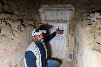 epa10431019 An Egyptian archaeologist speaks inside a tomb after the announcement of the new discoveries in Gisr el-Mudir in Saqqara, Giza, Egypt, in 26 January 2023. An Egyptian archaeological mission made a number of important archaeological discoveries dating to the fifth and sixth dynasties of the Old Kingdom. The announcement stated that the expedition had found a group of Old Kingdom tombs, indicating that the site comprised a large cemetery. The most important tomb belonged to Khnumdjedef, an inspector of the officials, a supervisor of the nobles, and a priest in the pyramid complex of Unas, the last king of the fifth dynasty. The tomb is decorated with scenes of daily life.  EPA/Mohamed Hossam ElDin