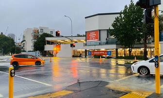 AUCKLAND, NEW ZEALAND - JANUARY 27: Cars drive through floodwaters on Victoria Street on January 27, 2023 in Auckland, New Zealand. Heavy rainfall has caused flash flooding and evacuations across the Auckland region. (Photo by Lynn Grieveson/Getty Images)