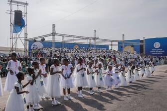 Attendees cheer as Pope Francis (not seen) arrives for the mass at the N'Dolo Airport in Kinshasa, Democratic Republic of Congo (DRC), on February 1, 2023. (Photo by Guerchom Ndebo / AFP) (Photo by GUERCHOM NDEBO/AFP via Getty Images)