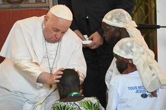 Pope Francis (L) blesses a child as he meets with victims of the conflict in eastern Democratic Republic of Congo (DRC) at the Apostolic Nunciature in Kinshasa, DRC, on February 1, 2023. - Pope Francis arrived in the Democratic Republic of Congo on January 31, 2023, on the first leg of a six-day trip to Africa that will also include troubled South Sudan. (Photo by Tiziana FABI / AFP) (Photo by TIZIANA FABI/AFP via Getty Images)