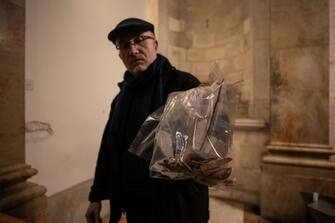 1246739961 JERUSALEM - FEBRUARY 02: A priest shows pieces statue of Jesus of Church of the Flagellation on the Via Dolorosa after an American tourist attacked and toppled it in the Old City of Jerusalem on February 02, 2023. (Photo by Mostafa Alkharouf/Anadolu Agency via Getty Images)