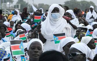 1246809855 Attendees hold South Sudan flags ahead of the holy mass with Pope Francis at the John Garang Mausoleum in Juba, South Sudan, on February 5, 2023. - Pope Francis wraps up his pilgrimage to South Sudan with an open-air mass on February 5, 2023 after urging its leaders to focus on bringing peace to the fragile country torn apart by violence and poverty.
The three-day trip is the first papal visit to the largely Christian country since it achieved independence from Sudan in 2011 and plunged into a civil war that killed nearly 400,000 people. (Photo by Simon MAINA / AFP) (Photo by SIMON MAINA/AFP via Getty Images)