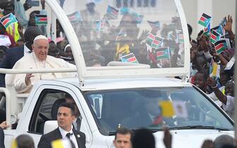 Pope Francis (L) waves as he arrives by popemobile for the holy mass at the John Garang Mausoleum in Juba, South Sudan, on February 5, 2023. - Pope Francis wraps up his pilgrimage to South Sudan with an open-air mass on February 5, 2023 after urging its leaders to focus on bringing peace to the fragile country torn apart by violence and poverty.
The three-day trip is the first papal visit to the largely Christian country since it achieved independence from Sudan in 2011 and plunged into a civil war that killed nearly 400,000 people. (Photo by Simon MAINA / AFP) (Photo by SIMON MAINA/AFP via Getty Images)