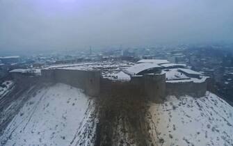 1246837091 GAZIANTEP, TURKIYE - FEBRUARY 6: An aerial view of damaged historical Gaziantep Castle after a 7.4 magnitude earthquake hit southern provinces of Turkiye, in Gaziantep, Turkiye on February 6, 2023. The 7.4 magnitude earthquake jolted Turkiyeâs southern province of Kahramanmaras early Monday, according to Turkiyeâs Disaster and Emergency Management Authority (AFAD). It was followed by a magnitude 6.4 quake that struck southeastern Gaziantep province. A third earthquake with a 6.5 magnitude also hit Gaziantep. Earthquakes had affected several provinces including, Osmaniye, Malatya, Adıyaman, Adana, Diyarbakır, Kilis and Sanliurfa. (Photo by Mehmet Akif Parlak/Anadolu Agency via Getty Images)