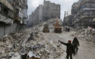 Syrian rescue teams search for victims and survivors in the city of Aleppo following a deadly earthquake on February 6, 2023. - The Syrian government urged the international community to come to its aid after more than 850 people died in the country following a 7.8-magnitude earthquake in neighbouring Turkey. (Photo by LOUAI BESHARA / AFP) / The erroneous mention[s] appearing in the metadata of this photo by LOUAI BESHARA has been modified in AFP systems in the following manner: [ALEPPO] instead of [HAMA]. Please immediately remove the erroneous mention[s] from all your online services and delete it (them) from your servers. If you have been authorized by AFP to distribute it (them) to third parties, please ensure that the same actions are carried out by them. Failure to promptly comply with these instructions will entail liability on your part for any continued or post notification usage. Therefore we thank you very much for all your attention and prompt action. We are sorry for the inconvenience this notification may cause and remain at your disposal for any further information you may require. (Photo by LOUAI BESHARA/AFP via Getty Images)