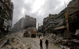 1246847692 EDITORS NOTE: Graphic content / Syrian rescue teams search for victims and survivors at the rubble a collapsed building in the city of Aleppo following a deadly earthquake on February 6, 2023. - The Syrian government urged the international community to come to its aid after more than 850 people died in the country following a 7.8-magnitude earthquake in neighbouring Turkey. (Photo by LOUAI BESHARA / AFP) (Photo by LOUAI BESHARA/AFP via Getty Images)