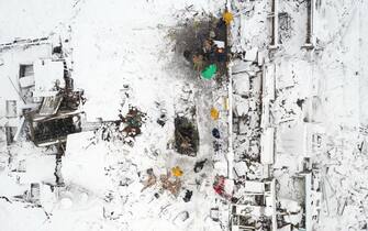MALATYA, TURKIYE - FEBRUARY 07: An aerial view of collapsed building as search and rescue efforts continue in Malatya after 7.7 and 7.6 magnitude earthquakes hit Kahramanmaras, Turkiye on February 7, 2023. Early Monday morning, a strong 7.7 earthquake, centered in the Pazarcik district, jolted Kahramanmaras and strongly shook several provinces, including Gaziantep, Sanliurfa, Diyarbakir, Adana, Adiyaman, Malatya, Osmaniye, Hatay, and Kilis. Later, at 13.24 p.m. (1024GMT), a 7.6 magnitude quake centered in Kahramanmaras' Elbistan district struck the region. Turkiye declared 7 days of national mourning after deadly earthquakes in southern provinces. (Photo by Hakan Burak Altunoz/Anadolu Agency via Getty Images)