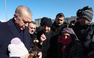 epa10454458 A handout photo made available by Turkey s Presidential press office shows Turkish President Recep Tayyip Erdogan (L) greeting people as he visits a tent camp in the aftermath of a major earthquake in Kahramanmaras, Turkey, 08 February 2023. More than 11,000 people have died and thousands more injured after two major earthquakes struck southern Turkey and northern Syria on 06 February. Authorities fear the death toll will keep climbing as rescuers look for survivors across the region.  EPA/MURAT CETINMUHURDAR/TURKISH PRESIDENTIAL PRESS OFFICE/HANDOUT  HANDOUT EDITORIAL USE ONLY/NO SALES