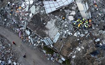 epa10452060 An aerial photo taken by a drone shows emergency personnel during a search and rescue operation at the site of a collapsed building after an earthquake in Iskenderun, district of Hatay, Turkey, 07 February 2023. More than 4,000 people were killed and thousands more injured after a major 7.8 magnitude earthquake struck southern Turkey and northern Syria on 06 February. Authorities fear the death toll will keep climbing as rescuers look for survivors across the region.  EPA/ERDEM SAHIN