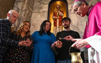DUBLIN, IRELAND - FEBRUARY 13: Bishop Denis Nulty performs a ritual for engaged couples in front of St. Valentine's relics and statue, on the eve of Saint Valentine 's Day at the Carmelite Church, in Dublin, Ireland on February 13, 2023. Valentine's Day, celebrated annually on February 14, originated as a holiday in honor of St. Valentine and has become an important cultural, religious and commercial celebration of romance and love in many regions of the world. (Photo by Artur Widak/Anadolu Agency via Getty Images)