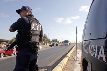 NUEVO LAREDO, MEXICO: Un miembro de la Policia Estatal participa de un operativo de seguridad en una da las carreteras que llevan al puente internacional con Estados Unidos, en Nuevo Laredo, noreste de la capital mexicana, el 17 de junio de 2005. En este operativo, denominado "Mexico Seguro", donde participan la Agencia Federal de Investigaciones (AFI), la Policia Federal Preventiva (PFP), la Policia Estatal y el Ejercito, y pretende combatir la violencia en el norte del pais, principalmente el narcotrafico. Nuevo Laredo, que hace frontera con Estados Unidos, ha registrado mas de 50 muertes violentas en lo que va del ano. AFP PHOTO/Alfredo ESTRELLA (Photo credit should read ALFREDO ESTRELLA/AFP via Getty Images)