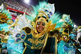 epa10479109 A member of the Imperio Serrano samba school parades in the sambadrome during carnival in Rio de Janeiro, Brazil, 19 February 2023.  EPA/André Coelho