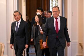 epa10483109 Russian Foreign Minister Sergei Lavrov (R) and China's Director of the Office of the Central Foreign Affairs Commission Wang Yi (L) enter a hall during a meeting in Moscow, Russia, 22 February 2023. Wang Yi arrived in Moscow on 21 February, and engaged in negotiations with the Secretary of the Security Council of the Russian Federation Nikolai Patrushev. At this meeting, Wang Yi stressed that Chinese-Russian relations are 'strong as a rock' and 'will stand the test in the changing international situation.' According to Wang Yi, Beijing is ready, together with Moscow, to resolutely defend national interests and promote mutually beneficial cooperation in all areas.  EPA/ALEXANDER NEMENOV / POOL