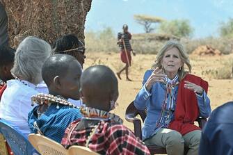 US First Lady Jill Biden  (R) meets with women from the Maasai community at Loseti village in Kajiado county, Kenya, on February 26, 2023 where she heard about the impoverishing impact of drought to the herder community during the third day of her visit to Kenya where she toured a drought response site to highlight the impacts of drought on communities. (Photo by Tony KARUMBA / AFP) (Photo by TONY KARUMBA/AFP via Getty Images)